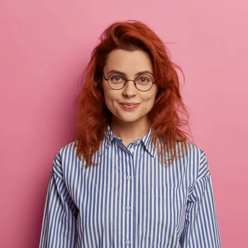Smiling woman with glasses and striped shirt, testimonial photo